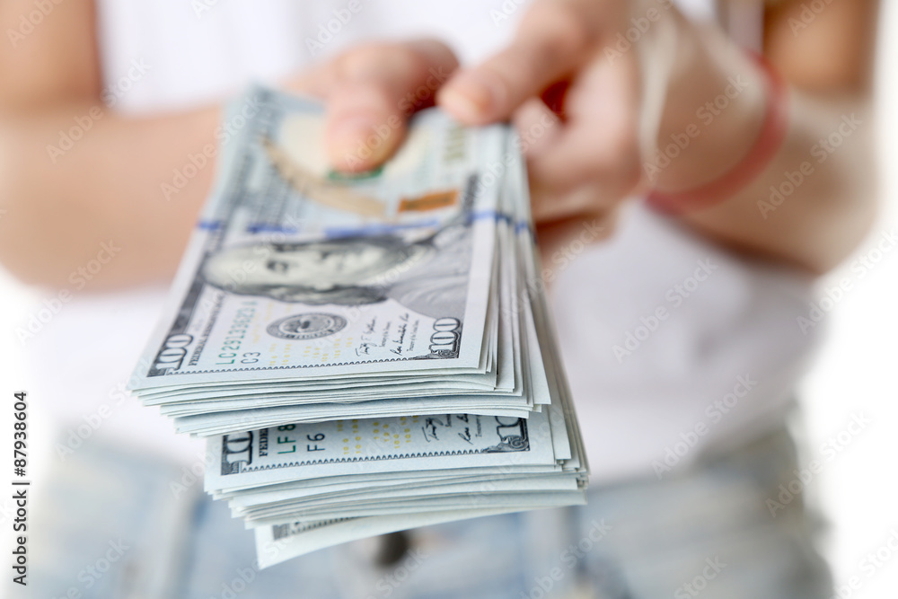 Female hands holding dollars, closeup