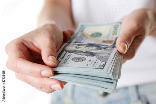 Female hands holding dollars, closeup