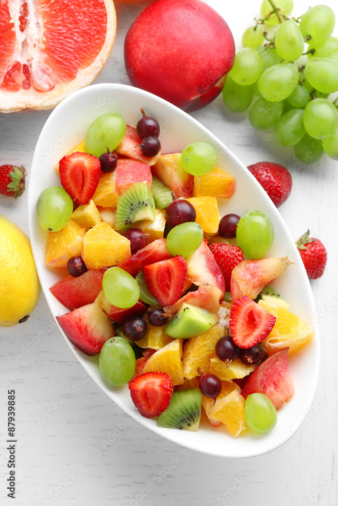 Fresh fruit salad on white wooden table