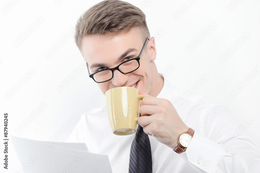 Businessman holding papers and cup of coffee Businessman holding papers and cup of coffee
