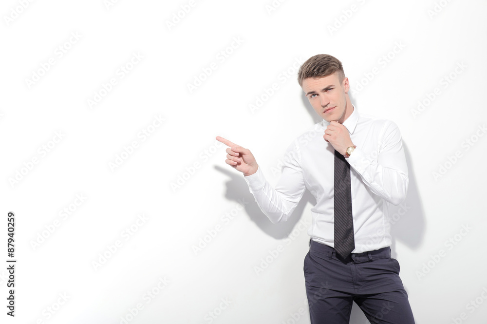 Businessman pointing aside with index finger Businessman pointing aside with index finger