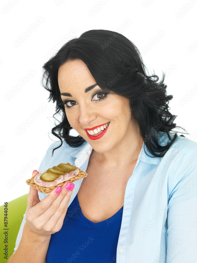 Young Woman Eating a Cracker with German Sausage and Gherkin Young Woman Eating a Cracker with German Sausage and Gherkin