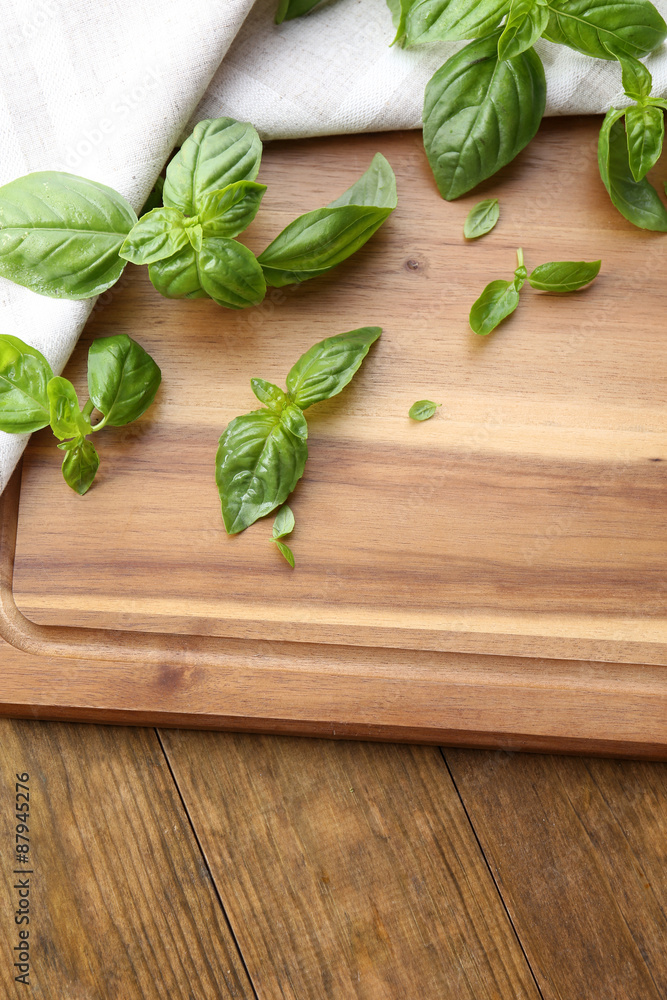 Green fresh basil with napkin on table close up