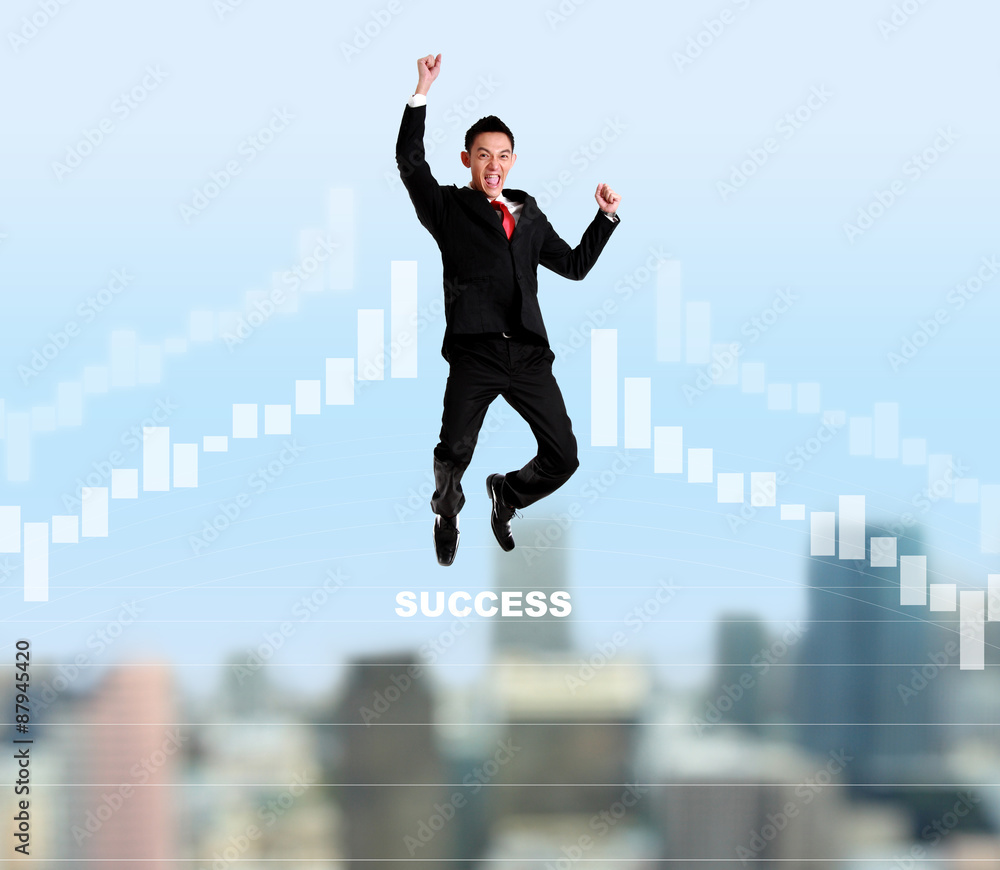 Yung businessman jumping and success graph with cityscape on the