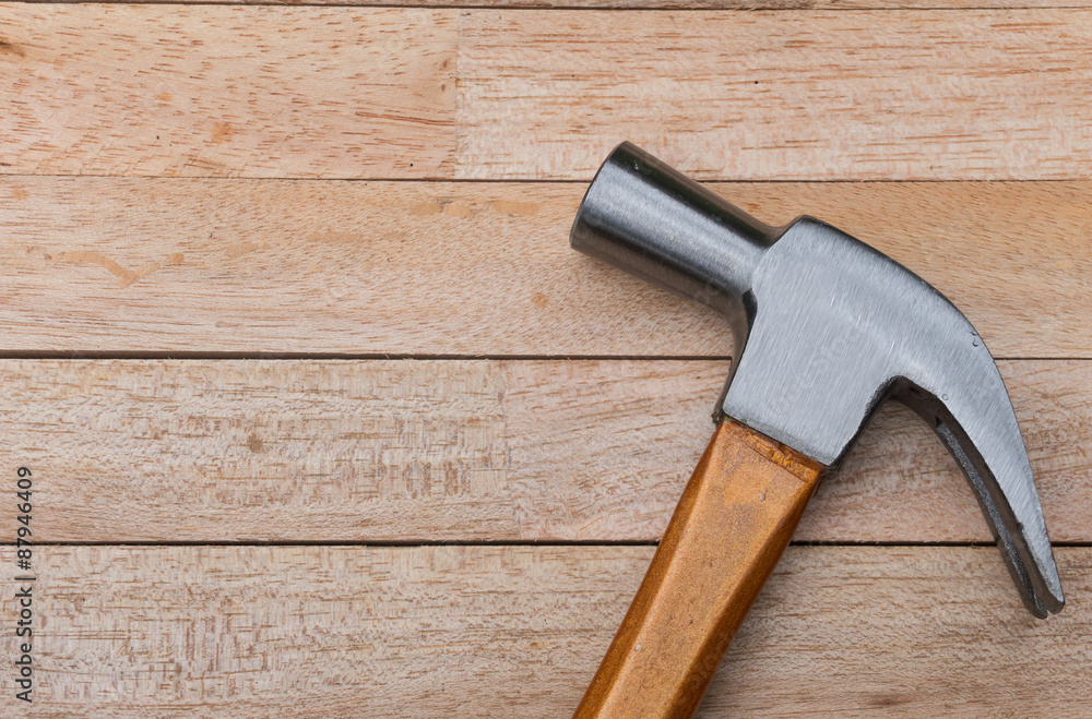 Hammer on wood background with copy space