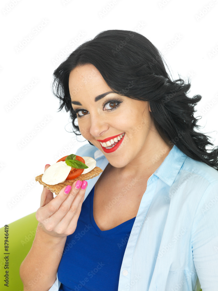 Young Woman Eating a Cracker with Mozzerella Cheese and Tomato