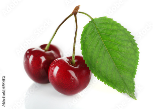 Fresh cherries with leaf isolated on white