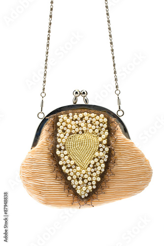 Fashionable handbag with pearls on white background.