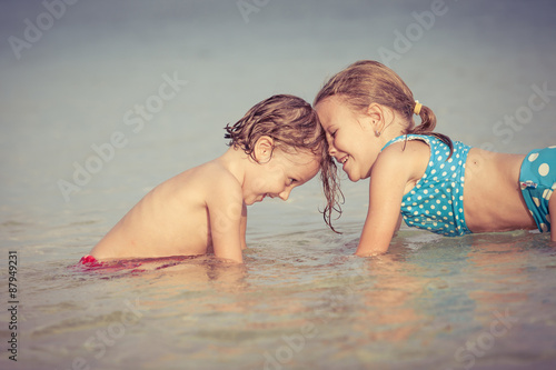 Two happy children  playing on the beach © altanaka