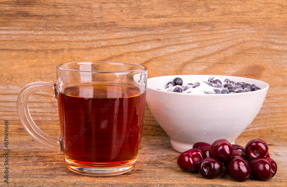 cup of tea sweet cherry and blueberry in white bowl on a wooden cup of tea sweet cherry and blueberry in white bowl on a wooden