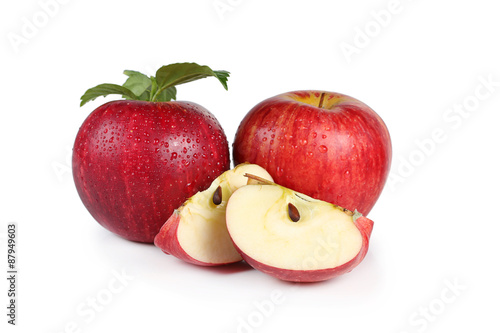 fresh red apples with leaves isolated on white background