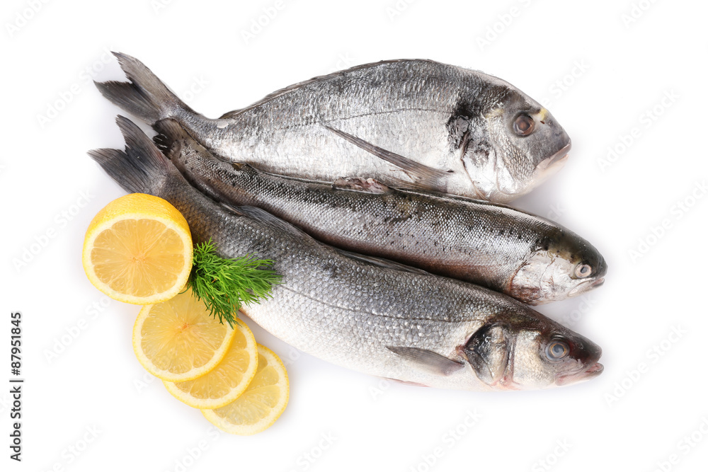 Fresh fish with dill and lemon isolated on white Fresh fish with dill and lemon isolated on white