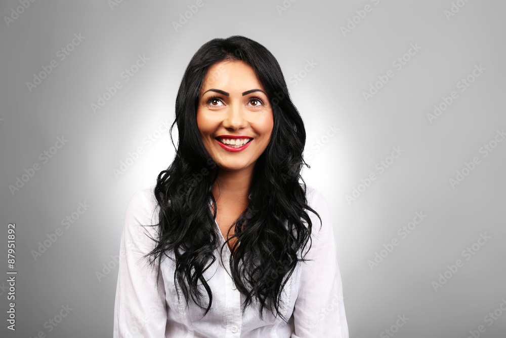 Portrait of pretty brunette on grey background Portrait of pretty brunette on grey background