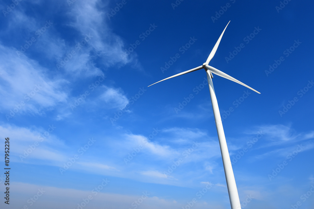 wind turbine against cloudy blue sky background wind turbine against cloudy blue sky background