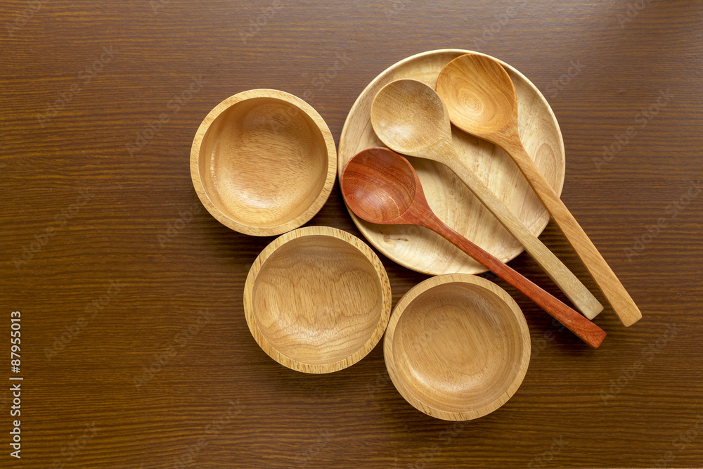Wooden kitchen utensils on wood background Wooden kitchen utensils on wood background