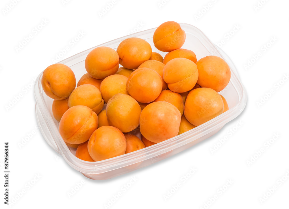 Ripe apricot in plastic tray closeup