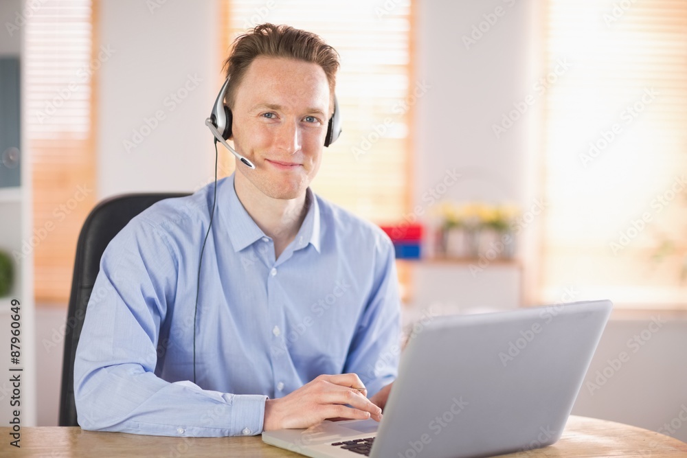 Casual businessman using headset on a call Casual businessman using headset on a call