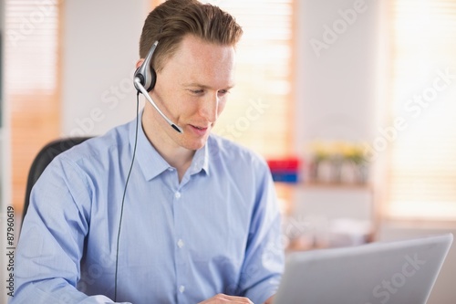 Casual businessman using headset on a call