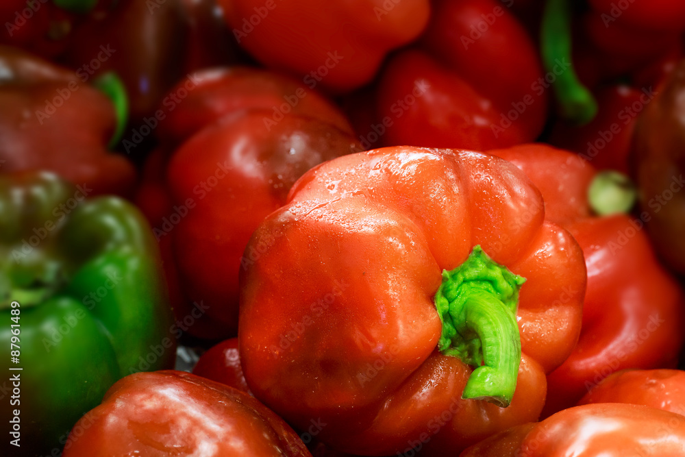 Red sweet pepper with blurred peppers on background Red sweet pepper with blurred peppers on background