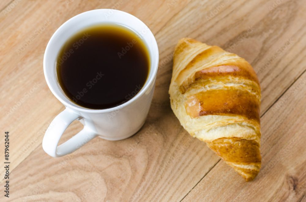 Breakfast cup of coffee and croissant. Breakfast cup of coffee and croissant.