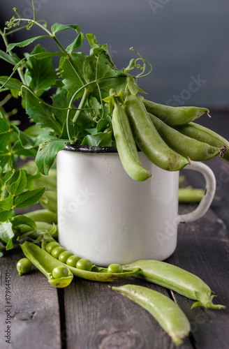 Ripe Green peas on wooden table.