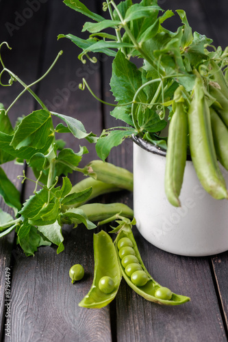 Ripe Green peas on wooden table.