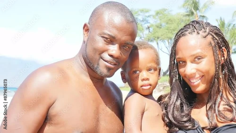 Black family smiles on a beach Black family smiles on a beach