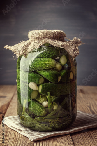 Jar of pickles on wooden table