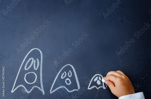 children's hand writing on a blackboard