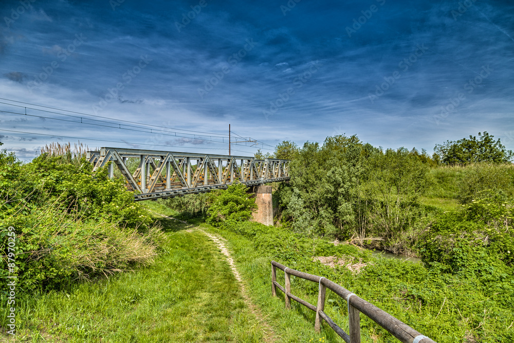 iron railway bridge in the middle of the Italian countryside
