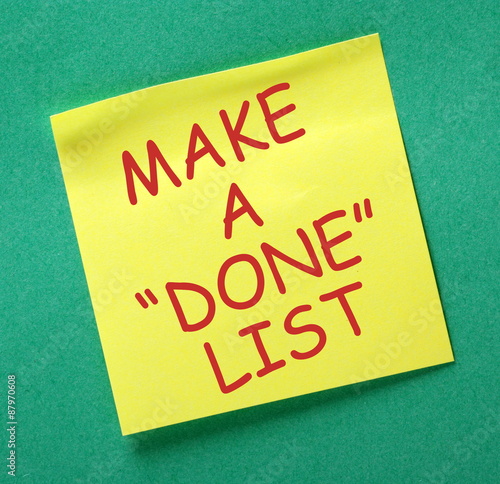 The phrase Make A Done List in red text on a yellow sticky note posted on a green notice board as a source of motivation