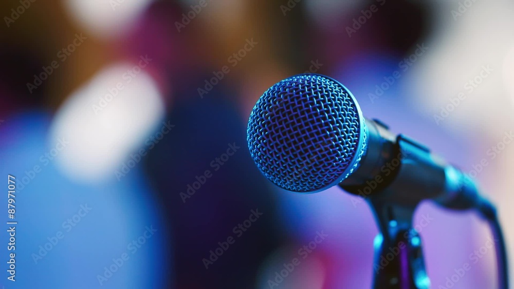 The microphone on the background of dancing people The microphone on the background of dancing people