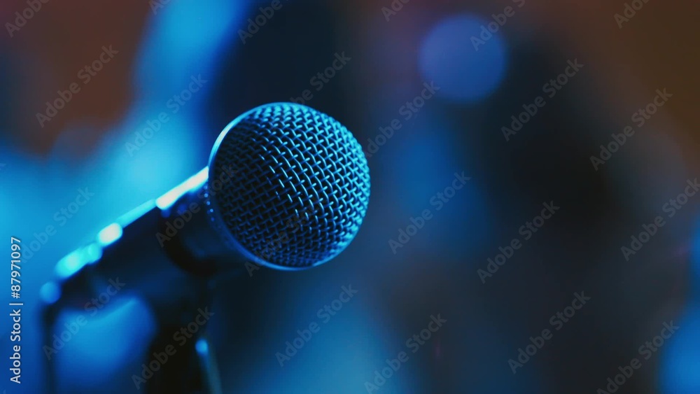The microphone on the background of dancing people The microphone on the background of dancing people