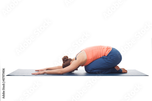 Beautiful sporty fit yogi girl practices yoga asana balasana
 photo