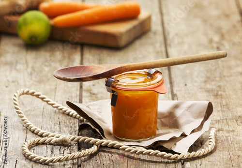 Handmade chutney from carrots, ginger and lime in jar photo