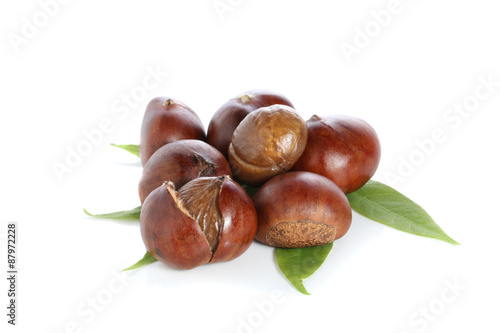 Chestnuts with chestnut leafs isolated on white