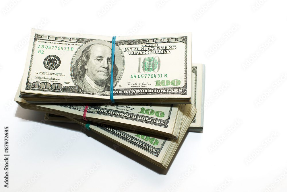 Bundles of US dollars banknotes on a white background Bundles of US dollars banknotes on a white background