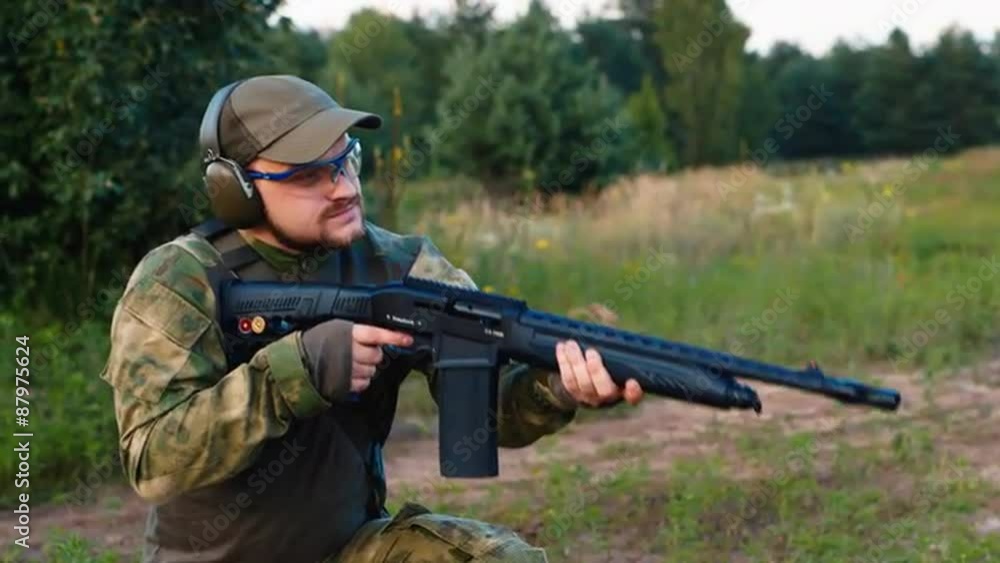 Military man shooting a gun Military man shooting a gun