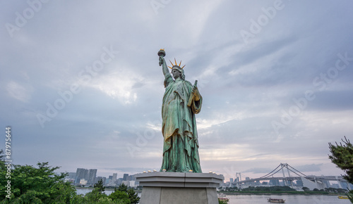 Statue of Liberty and Rainbow bridge in Odaiba at sunset