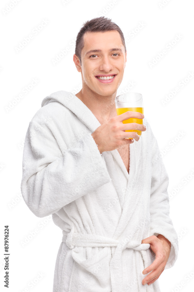 Man in a white bathrobe holding orange juice Man in a white bathrobe holding orange juice