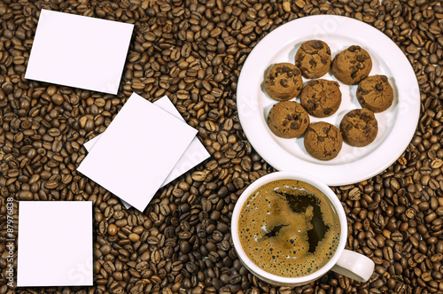 Coffee bean background with cup of fresh hot coffee and croissan photo