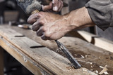 Hands of carpenter with chisel in the hands
