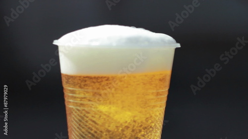 Plastic glass with beer