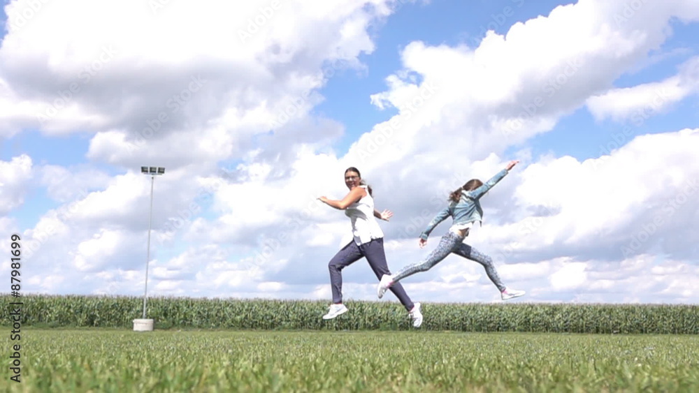Young girls jumping in home garden .Slow motion. Young girls jumping in home garden .Slow motion.