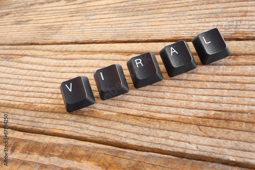 "VIRAL" wrote with keyboard keys on wooden background