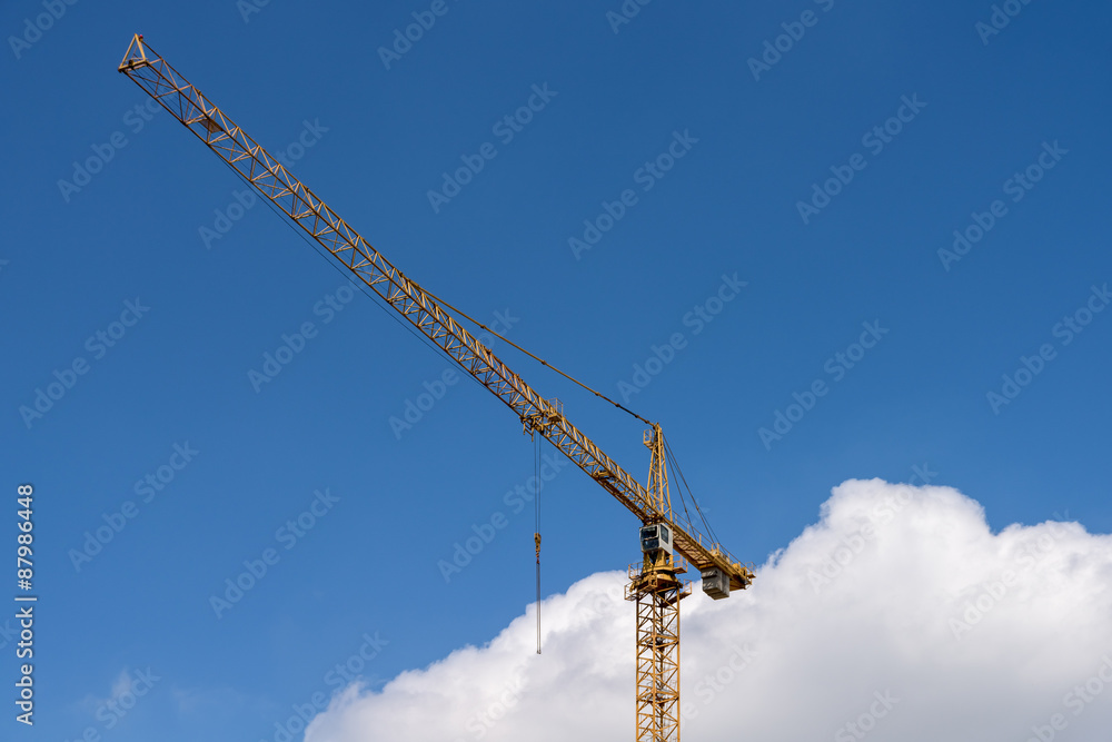 Industrial Construction Crane Against Blue Sky With Clouds