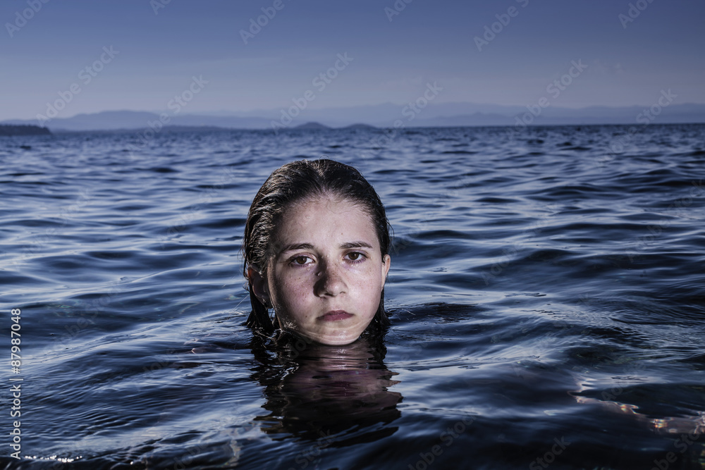 Girl immersed in sea waves