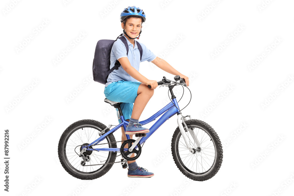 Fototapeta premium Studio shot of a schoolboy riding a bicycle