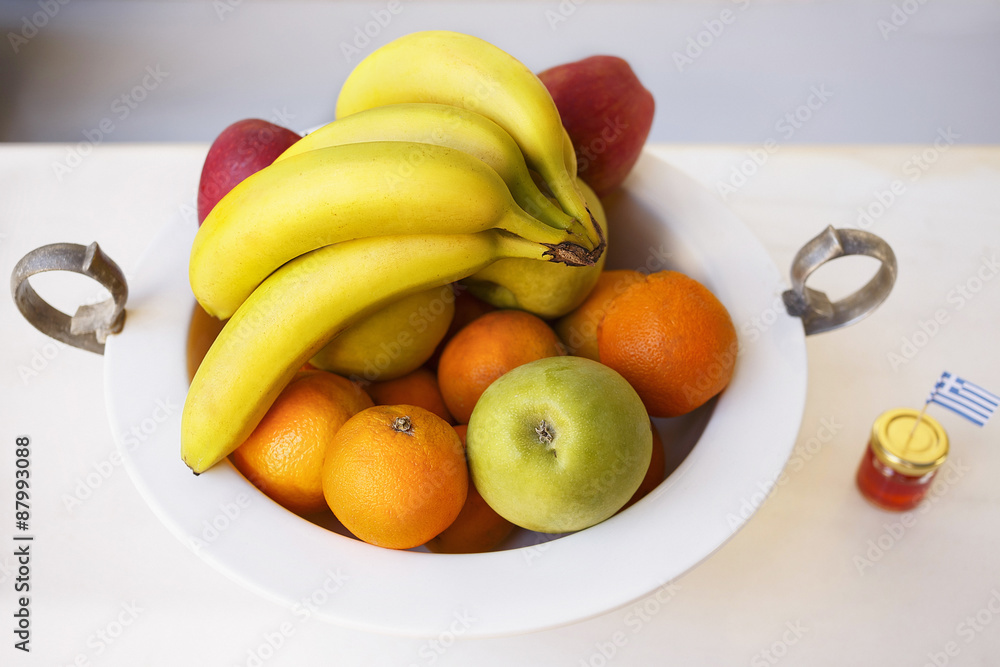 Fruit bowl/Fruit in deep plate, bananas, apples and oranges, honey Fruit bowl/Fruit in deep plate, bananas, apples and oranges, honey