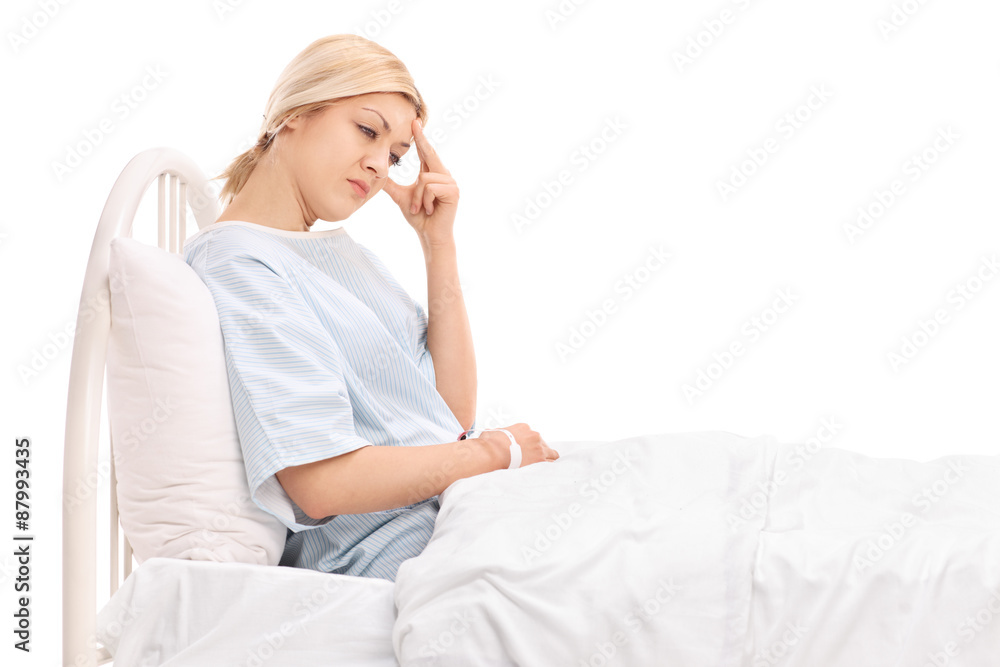 Female patient lying in a hospital and having a headache Female patient lying in a hospital and having a headache